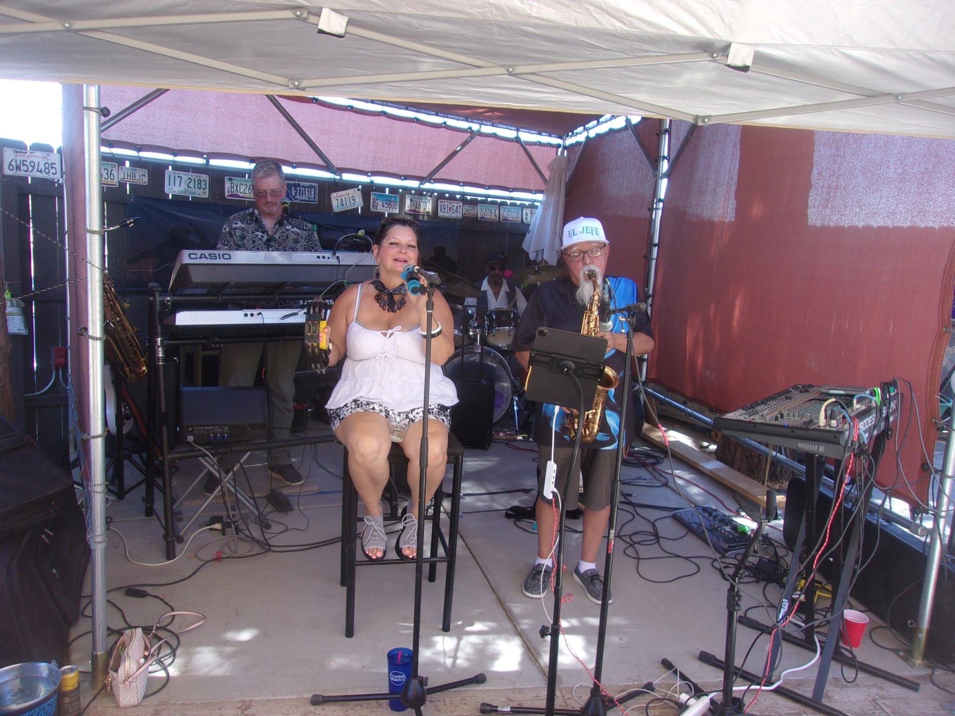 Leather & Lace performing live under a tent stage with the full band