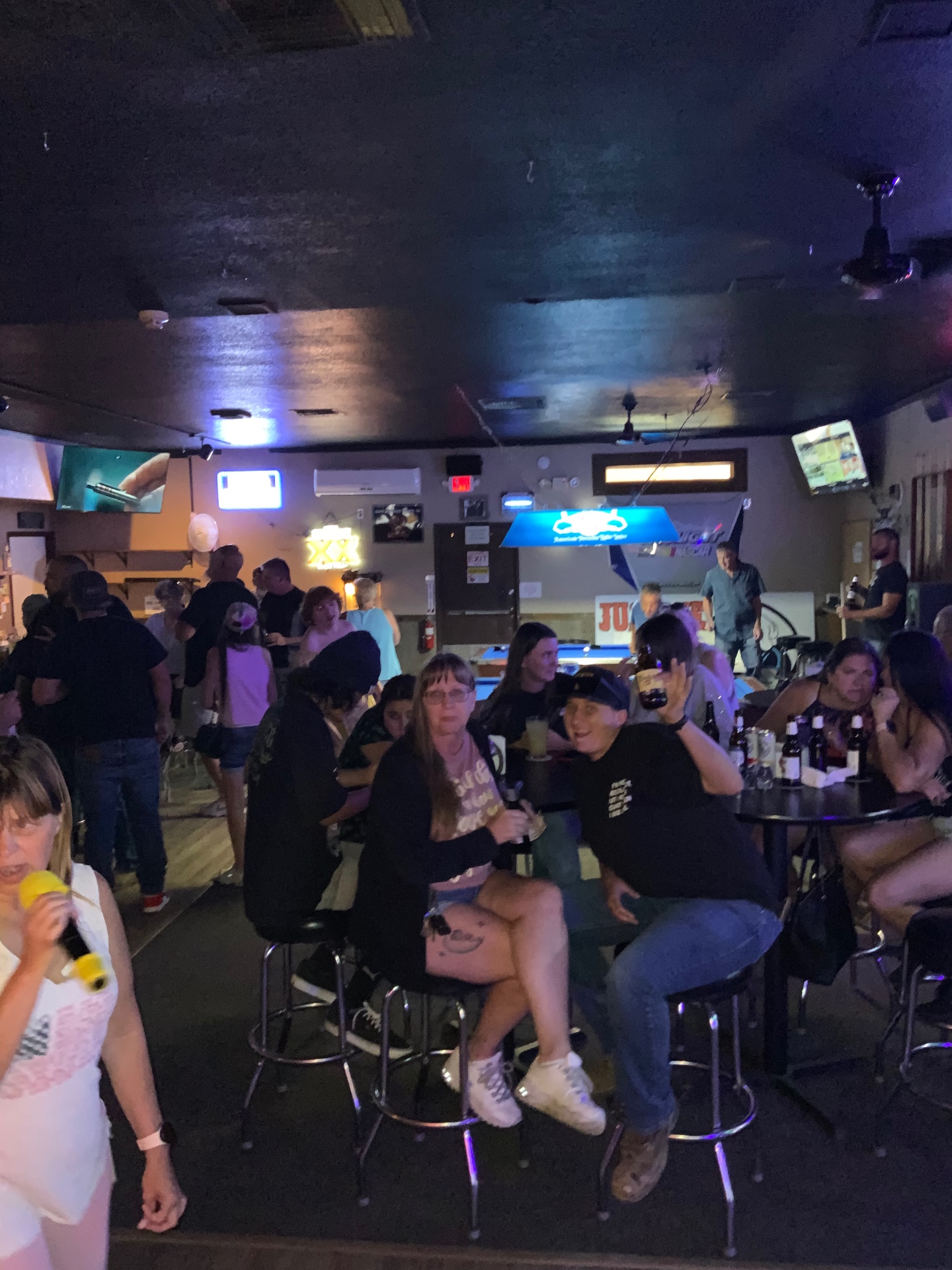 Packed karaoke night crowd singing at a Leather & Lace hosted event