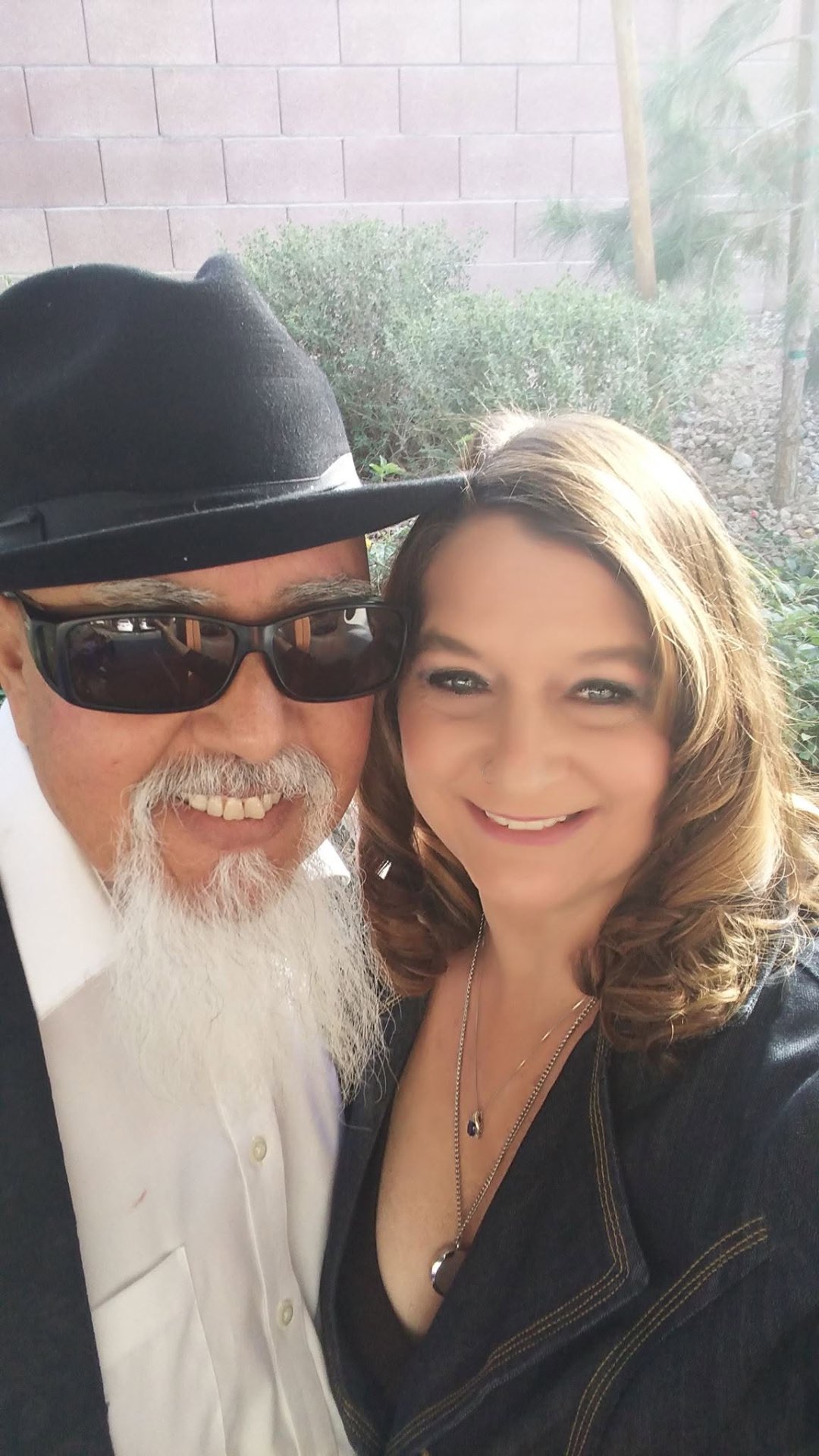 Laurie and Raul dressed up outdoors before an event